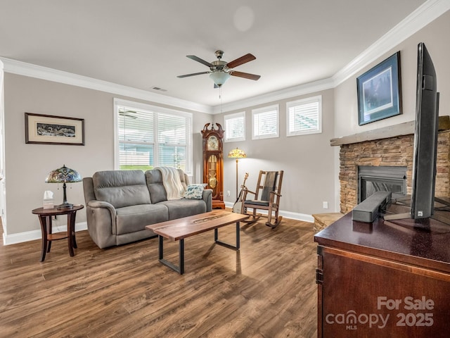 775 Summerfield Pl, Flat Rock, NC 28731 - living room with baseboards, ceiling fan, crown molding, a stone fireplace, and dark wood-type flooring