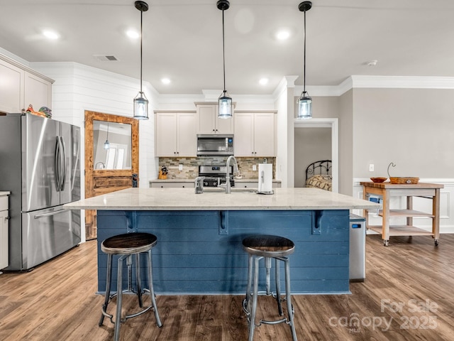 775 Summerfield Pl, Flat Rock, NC 28731 - kitchen with light stone counters, a sink, appliances with stainless steel finishes, ornamental molding, and visible vents