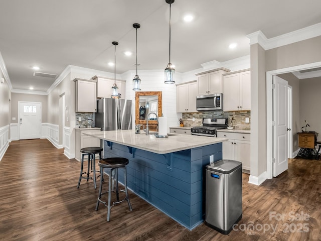 775 Summerfield Pl, Flat Rock, NC 28731 - kitchen with light stone counters, a sink, crown molding, appliances with stainless steel finishes, and a breakfast bar area