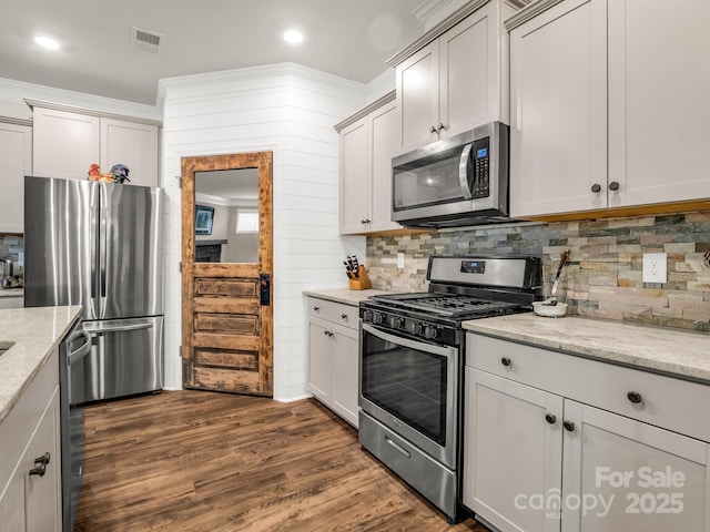 775 Summerfield Pl, Flat Rock, NC 28731 - kitchen with dark wood-type flooring, tasteful backsplash, light stone countertops, and appliances with stainless steel finishes