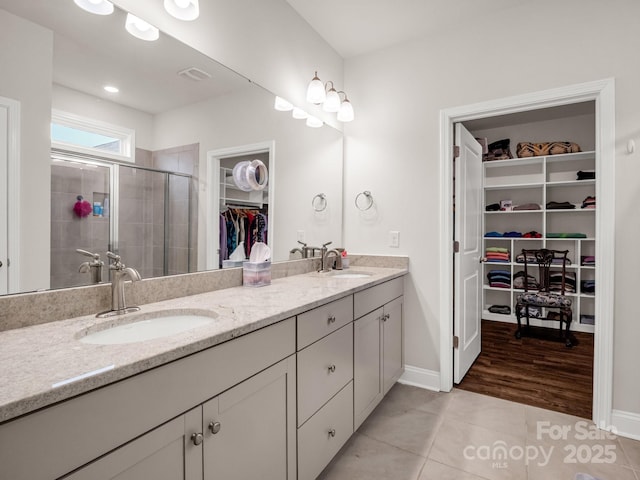 775 Summerfield Pl, Flat Rock, NC 28731 - full bathroom featuring double vanity, tile patterned flooring, a stall shower, and a sink
