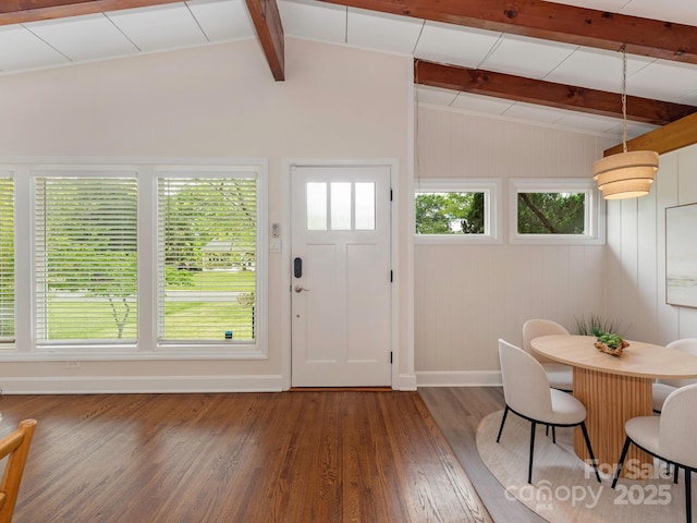 foyer featuring lofted ceiling with beams, baseboards, and wood finished floors