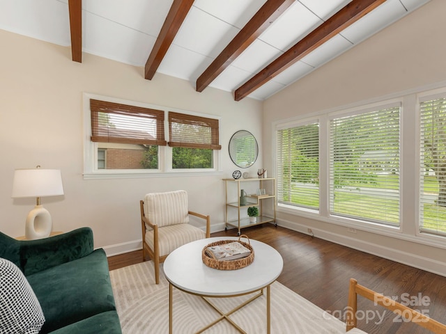 living room featuring wood finished floors, vaulted ceiling with beams, and baseboards