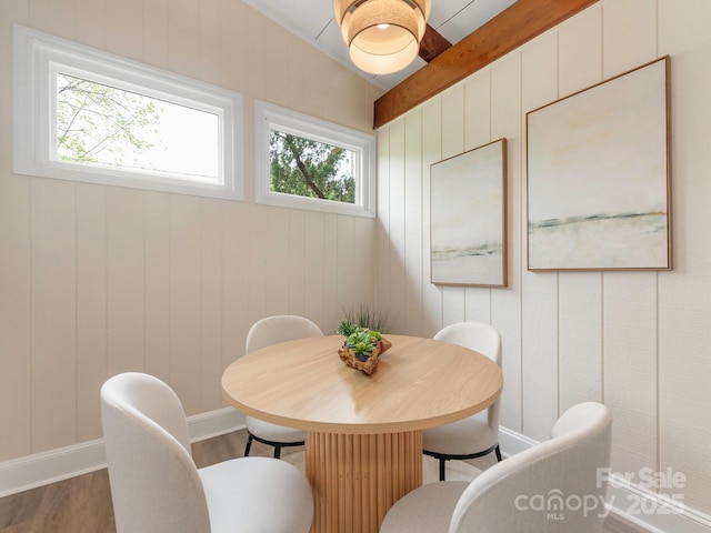 dining area featuring baseboards and wood finished floors