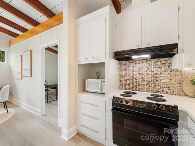kitchen featuring black / electric stove, under cabinet range hood, light countertops, white microwave, and tasteful backsplash