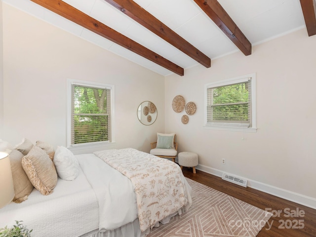bedroom with baseboards, multiple windows, visible vents, and vaulted ceiling with beams