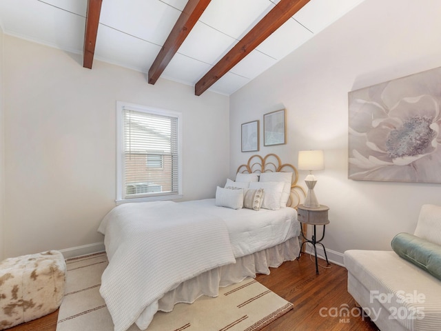 bedroom featuring vaulted ceiling with beams, wood finished floors, and baseboards