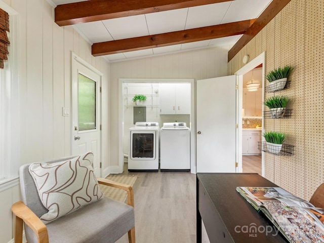 laundry room with cabinet space, light wood-style flooring, and washer and dryer