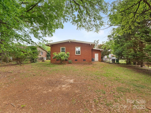 exterior space featuring brick siding and crawl space