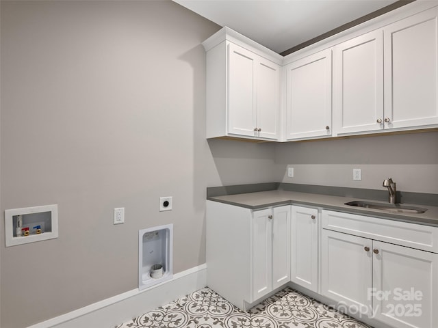 washroom with cabinet space, electric dryer hookup, a sink, washer hookup, and light tile patterned floors