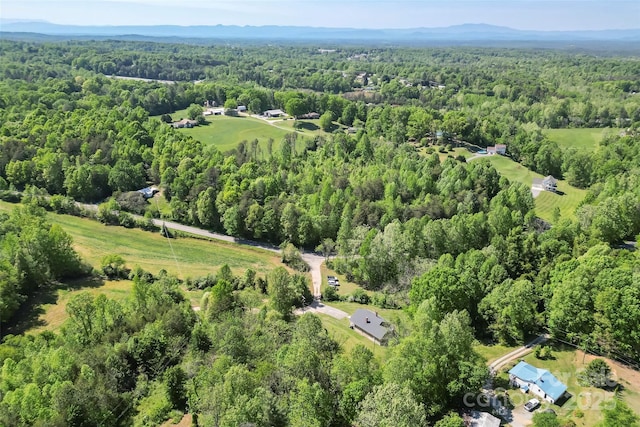 drone / aerial view featuring a forest view