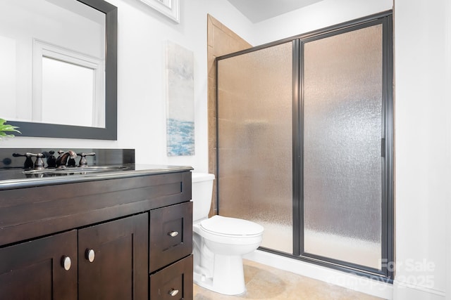 bathroom with vanity, tile patterned floors, toilet, and a shower stall