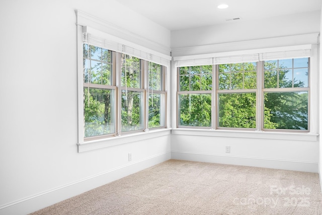 unfurnished sunroom featuring visible vents