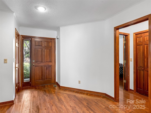 3 Governors Dr, Asheville, NC 28804 - entrance foyer with crown molding, baseboards, a textured ceiling, and wood finished floors