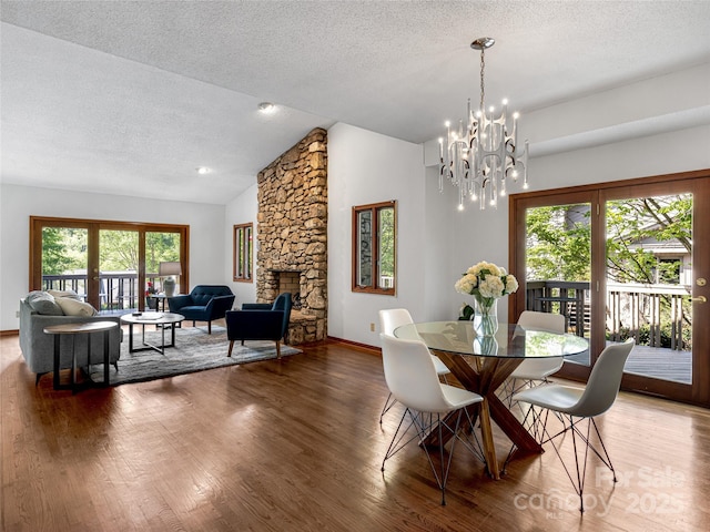 3 Governors Dr, Asheville, NC 28804 - dining space featuring a chandelier, a textured ceiling, vaulted ceiling, and wood finished floors