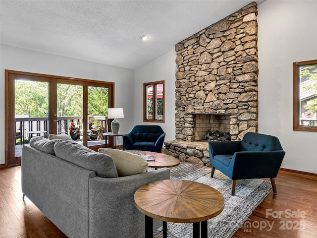 3 Governors Dr, Asheville, NC 28804 - living area featuring a textured ceiling, lofted ceiling, wood finished floors, and a fireplace