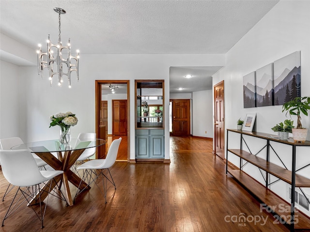 3 Governors Dr, Asheville, NC 28804 - dining space featuring dark wood-type flooring, a textured ceiling, and an inviting chandelier