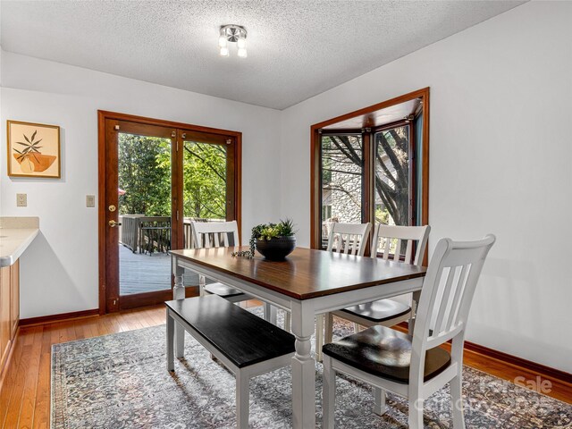3 Governors Dr, Asheville, NC 28804 - dining area featuring baseboards, light wood finished floors, and a textured ceiling