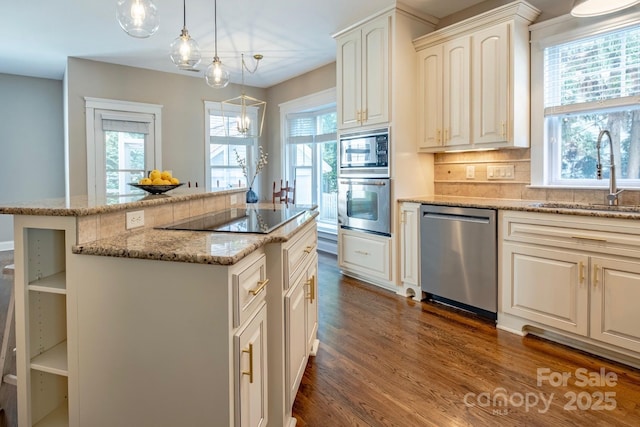 7409 Gilderstern Glen Ct, Huntersville, NC 28078 - kitchen with appliances with stainless steel finishes, a sink, decorative backsplash, dark wood-type flooring, and pendant lighting