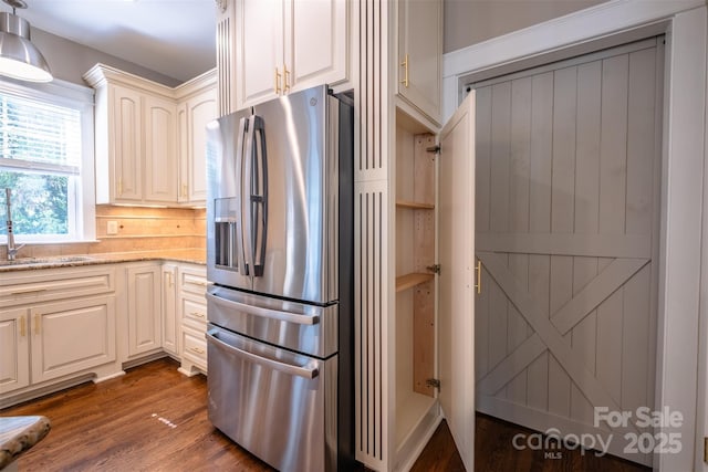 7409 Gilderstern Glen Ct, Huntersville, NC 28078 - kitchen featuring stainless steel refrigerator with ice dispenser, a sink, dark wood finished floors, and light stone counters