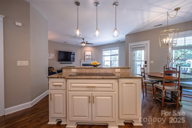 7409 Gilderstern Glen Ct, Huntersville, NC 28078 - kitchen with visible vents, dark wood finished floors, black electric cooktop, ceiling fan with notable chandelier, and white cabinetry