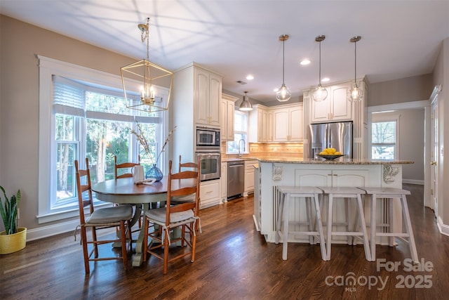 7409 Gilderstern Glen Ct, Huntersville, NC 28078 - dining area with an inviting chandelier, a wealth of natural light, and dark wood finished floors