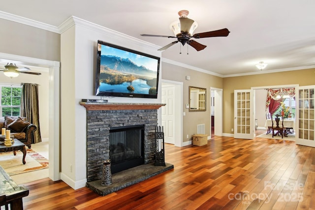 living room featuring visible vents, ceiling fan, and wood finished floors