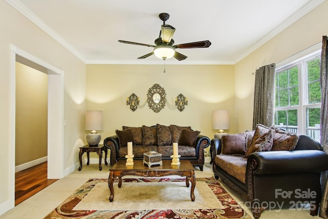 carpeted living area with crown molding, a ceiling fan, and baseboards