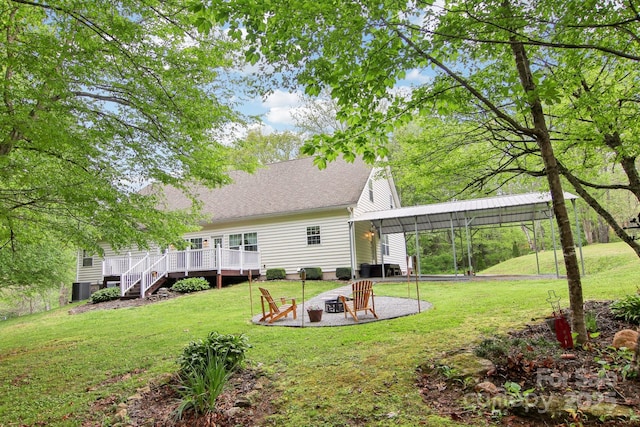 rear view of property with roof with shingles, a wooden deck, stairway, an outdoor fire pit, and a yard