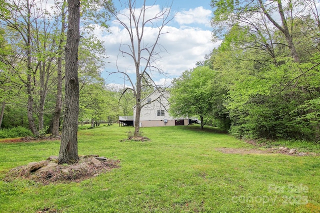 view of yard with a view of trees
