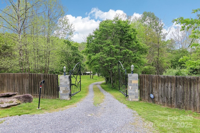 view of road featuring driveway and a gated entry
