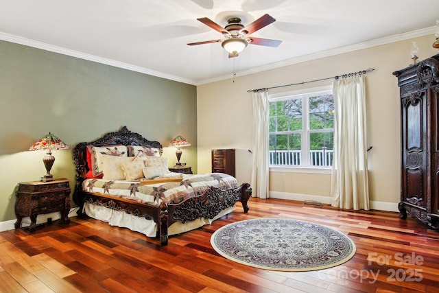 bedroom with a ceiling fan, baseboards, ornamental molding, and wood finished floors