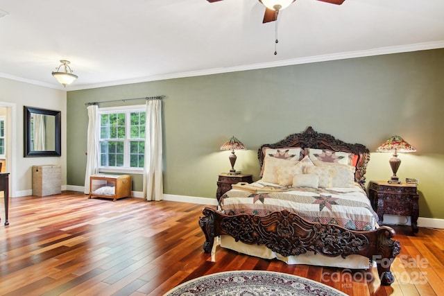 bedroom featuring baseboards, ornamental molding, a ceiling fan, and hardwood / wood-style flooring