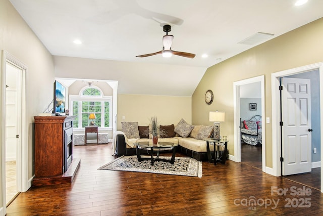 living room featuring baseboards, wood-type flooring, a ceiling fan, and visible vents