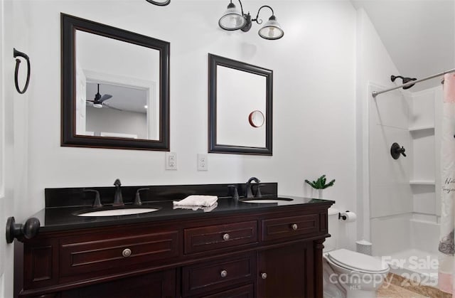 full bath featuring a sink, double vanity, toilet, and curtained shower