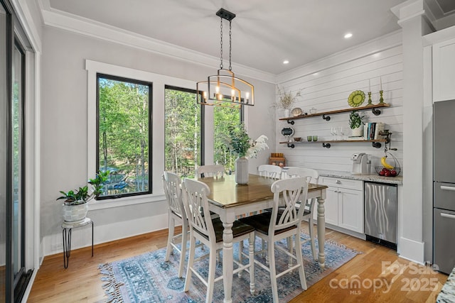 dining area featuring light wood-style flooring, baseboards, an inviting chandelier, recessed lighting, and ornamental molding