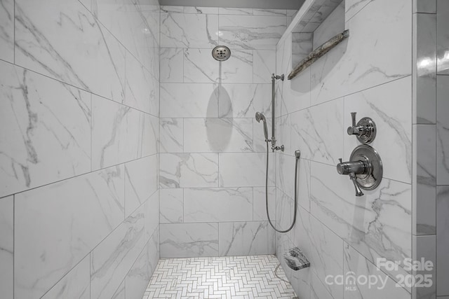 full bath featuring tiled shower