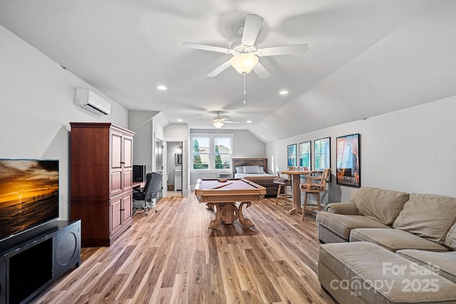 rec room with light wood-style flooring, an AC wall unit, vaulted ceiling, recessed lighting, and a ceiling fan