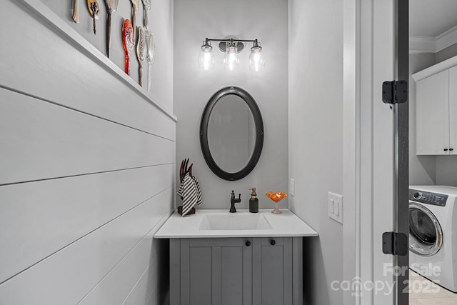 bathroom with vanity and washer / clothes dryer