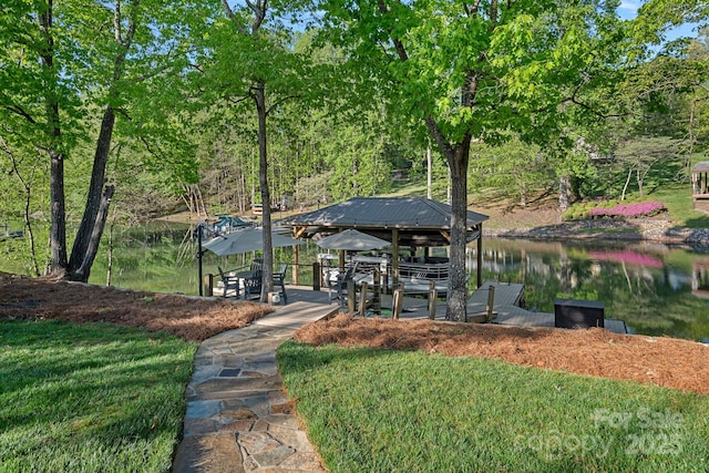 surrounding community with a lawn and a water view