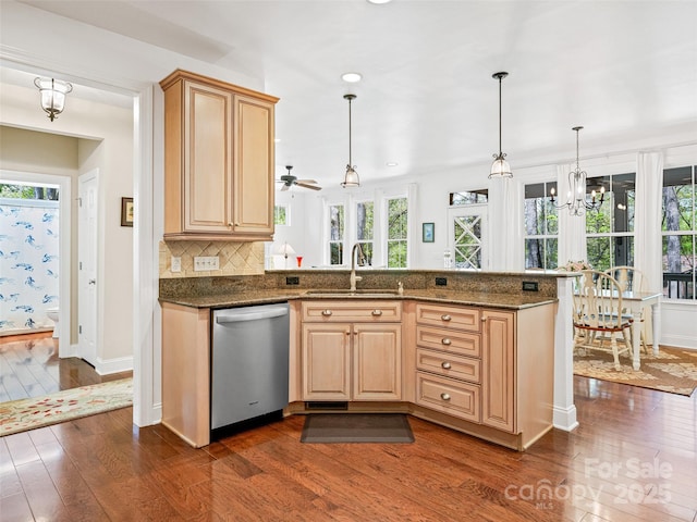 kitchen with dishwasher, dark wood-style flooring, a sink, and plenty of natural light