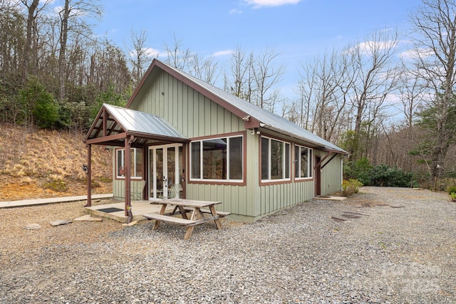 view of property exterior featuring french doors and metal roof