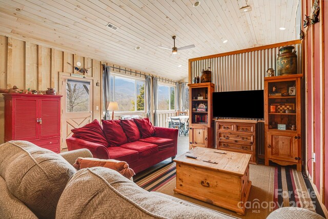 living room featuring wood ceiling, a ceiling fan, and visible vents