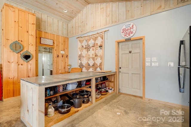 interior space featuring lofted ceiling, baseboards, wooden ceiling, and wooden walls