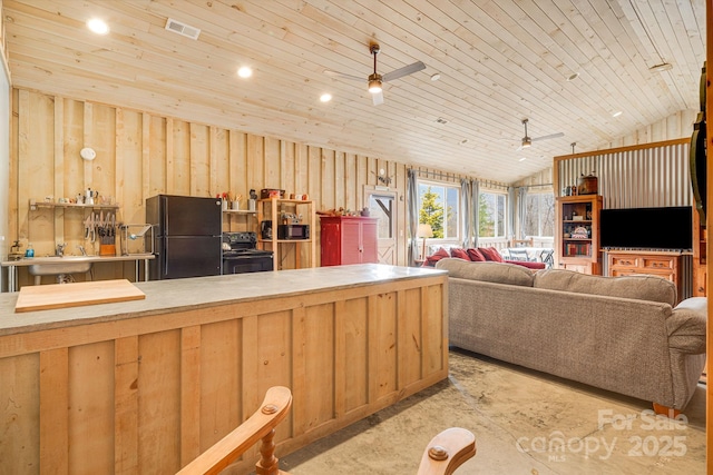 kitchen featuring a sink, vaulted ceiling, visible vents, ceiling fan, and black appliances