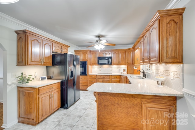kitchen with black appliances, a sink, tasteful backsplash, a peninsula, and ceiling fan