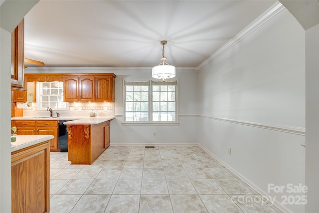 kitchen with a peninsula, plenty of natural light, light countertops, decorative backsplash, and ornamental molding