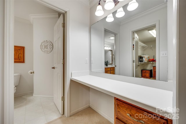bathroom featuring toilet, crown molding, baseboards, and tile patterned flooring