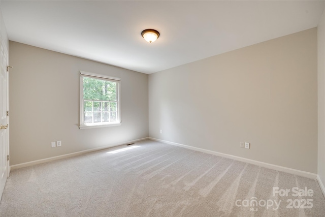 empty room featuring baseboards and carpet floors