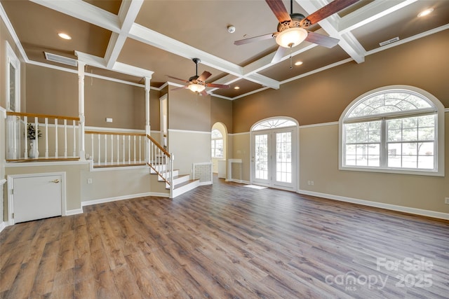 unfurnished living room featuring coffered ceiling, a ceiling fan, beamed ceiling, stairs, and wood finished floors